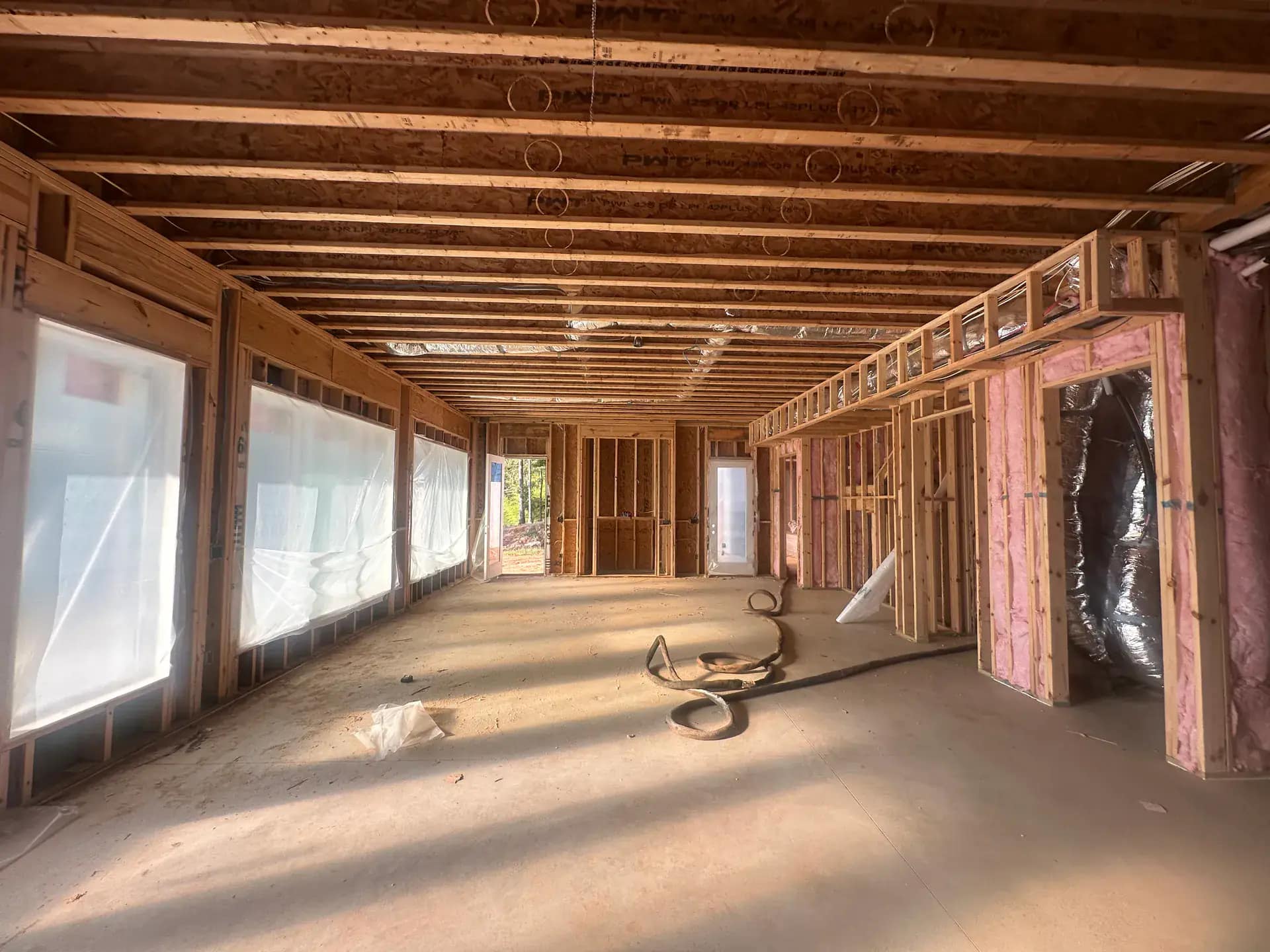 Spray foam applied around HVAC ductwork for complete building envelope sealing